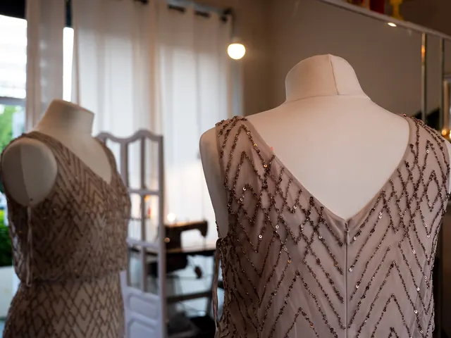 Two beaded evening dresses on mannequins