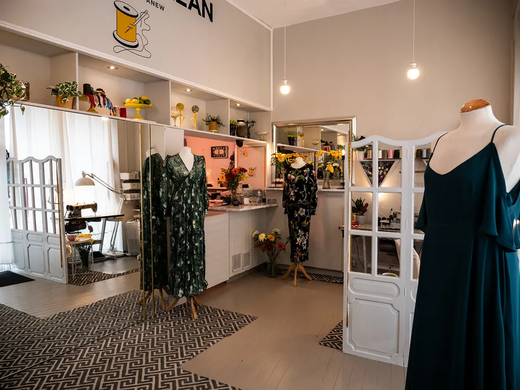 Inside the shop: bright shelves, flowers and dresses on mannequins